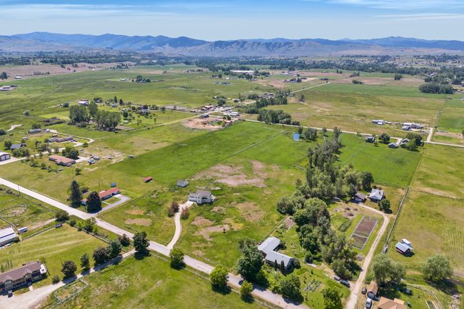 Aerial view of property and surrounding area featuring rural landscape, a mountainous background, and a pastoral area | Image 62