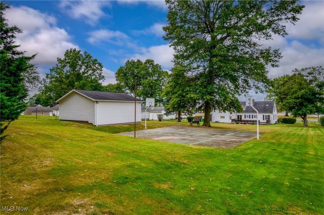 View of yard featuring basketball court | Image 5