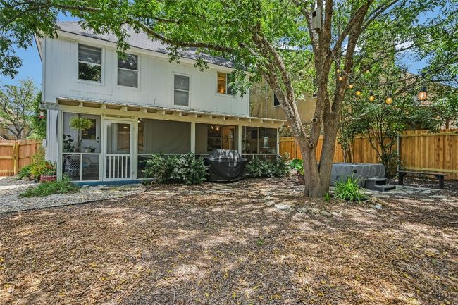 Heavily shaded backyard with native landscapes and recent fencing. | Image 10