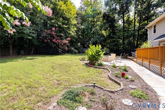 Fenced backyard with a patio area | Image 47