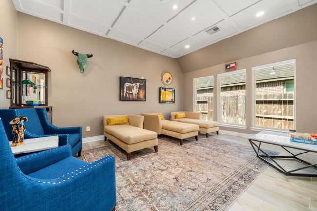 Perfect for entertaining is this amazing game room! Right off the kitchen is this room that would be a fabulous teen hangout, media room, or adult game room complete with pool table and big screen TVs. Featuring vinyl flooring, high trey ceilings, custom paint and large windows with privacy blinds. | Image 19