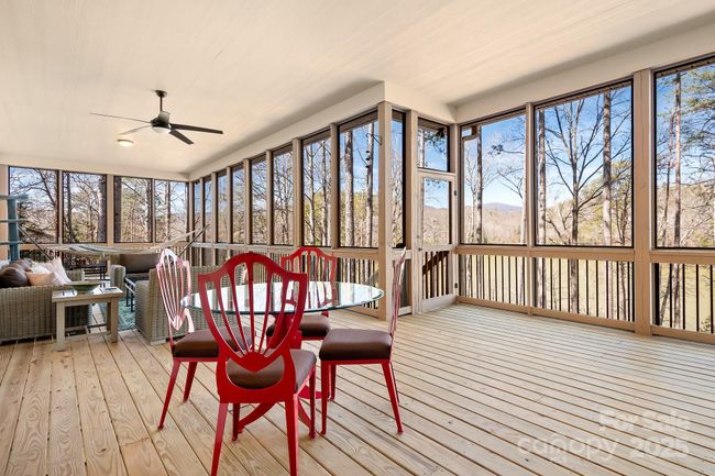 Covered Screened in space with beautiful decking, ceiling fans and sweeping views of Lake Adger, your private floaiting dock, soaring pine trees and more! Perfect for Entertaining. | Image 30