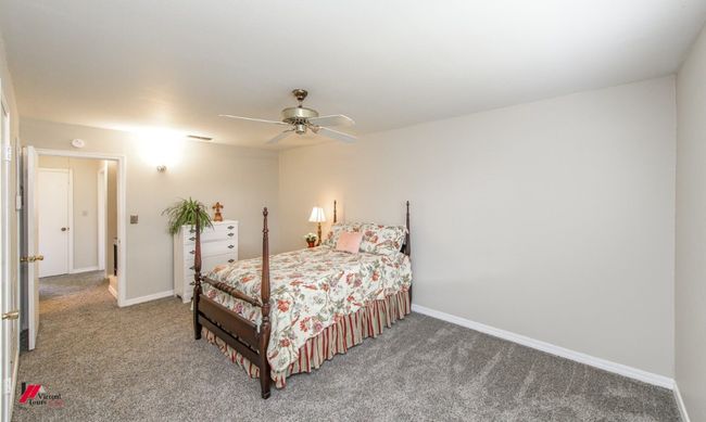 Bedroom with baseboards, visible vents, carpet, and a ceiling fan | Image 17