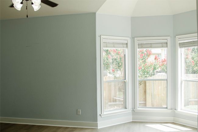 Unfurnished room featuring a ceiling fan, wood finished floors, and plenty of natural light | Image 16