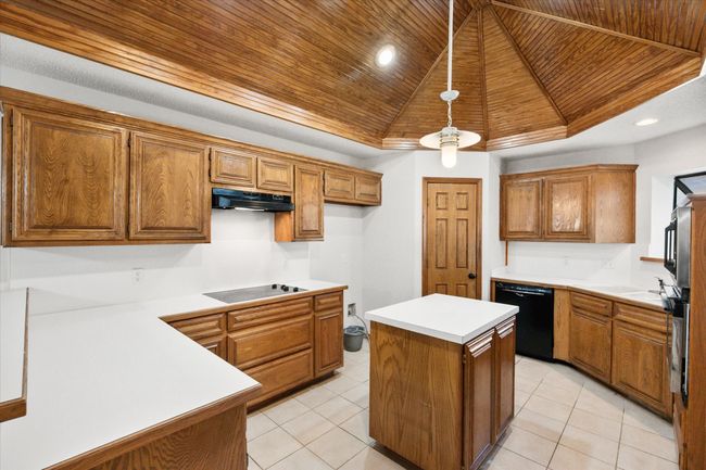 There is a water line for the fridge, a glass top cooktop and a ton of counter space. | Image 22