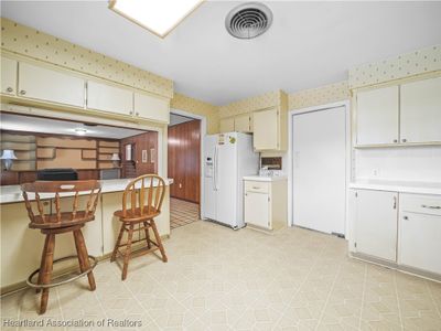 KITCHEN TO FAMILY ROOM VIEW - DOOR TO RIGHT LEADS TO FORMAL DINING AND LIVING ROOM | Image 3