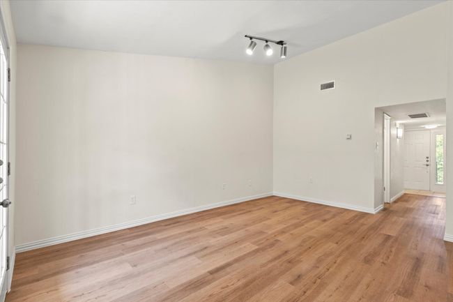 View from the living room towards the hallway and kitchen | Image 12