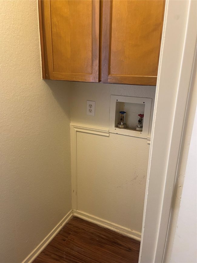 Washroom featuring washer hookup, cabinet space, and dark wood finished floors | Image 9