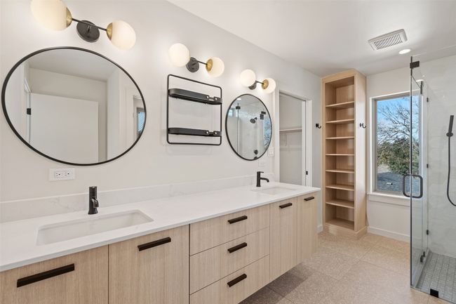 Full bath featuring double vanity, a stall shower, a sink, and visible vents | Image 17