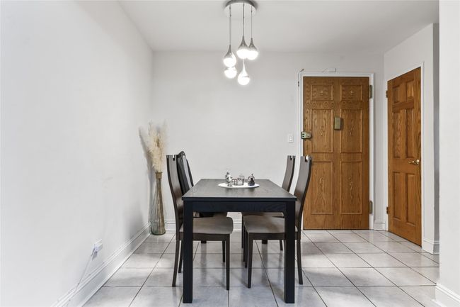 Dining area with light tile patterned flooring and baseboards | Image 4