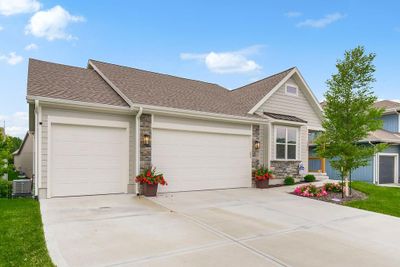 View of front of home with a garage and central AC | Image 1