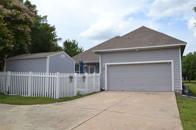 View of front of home with roof with shingles, driveway, and an attached garage | Image 22
