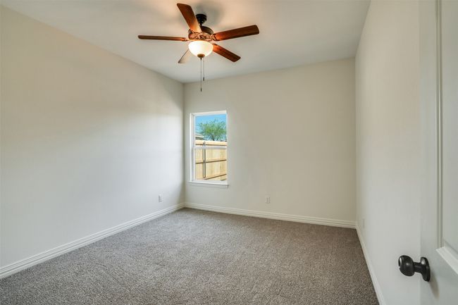 Spare room with baseboards, a ceiling fan, and carpet | Image 20