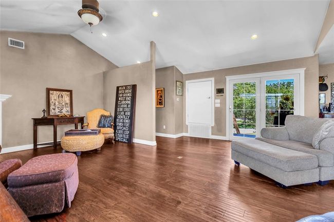 Living room featuring ceiling fan, high vaulted ceiling, baseboards, dark wood finished floors, and recessed lighting | Image 4