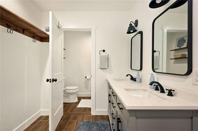 Full bath with wood tiled floors, double vanity. | Image 48