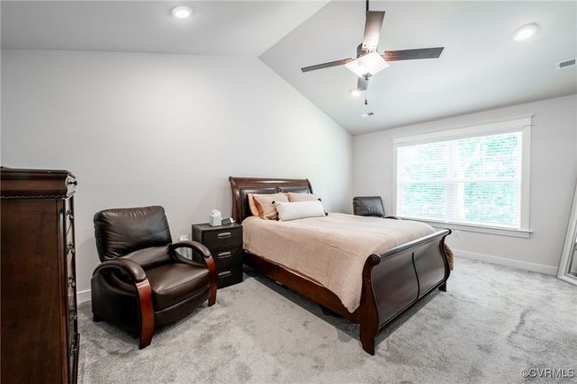 Primary Bedroom featuring lofted ceiling, light colored carpet, a ceiling fan, and recessed lighting | Image 18