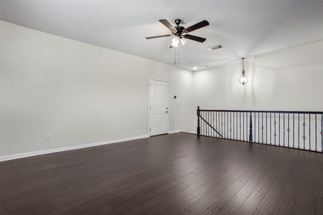 Spare room with ceiling fan, dark wood-style flooring, and baseboards | Image 33
