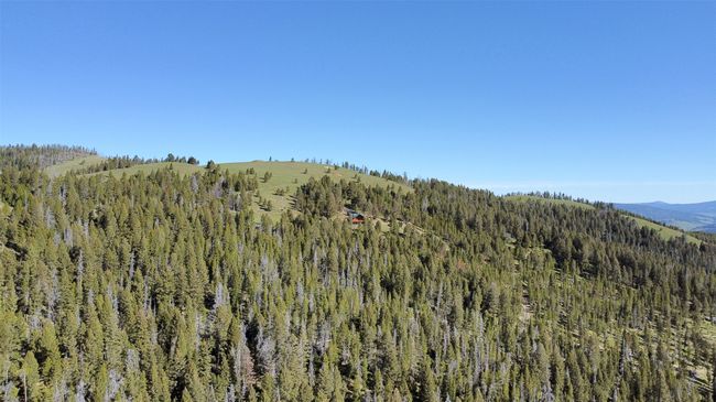 View of mountain backdrop featuring a heavily wooded area | Image 79