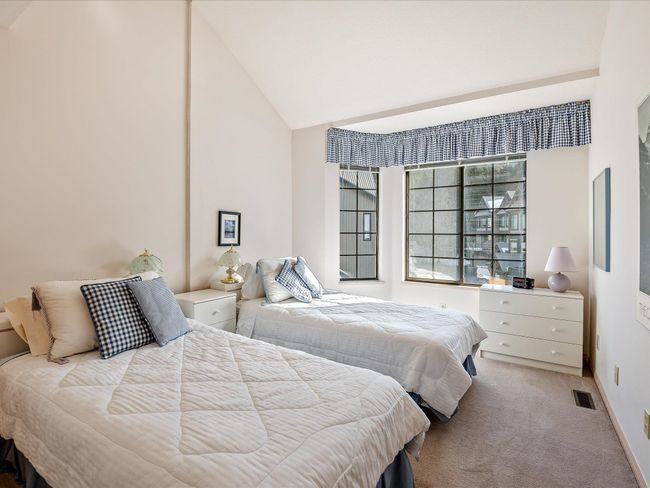 Bedroom with lofted ceiling, carpet flooring, visible vents, and baseboards | Image 20