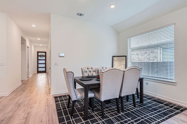 Dining space featuring light wood-style floors, visible vents, baseboards, and a healthy amount of sunlight | Image 9