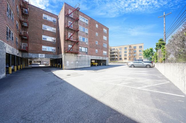 View of apartment building / complex with uncovered parking | Image 16