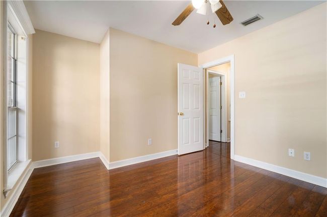 Empty room featuring a ceiling fan and wood-type flooring | Image 21