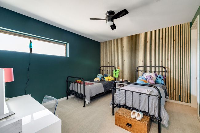 Bedroom featuring carpet floors, an accent wall, and ceiling fan | Image 30