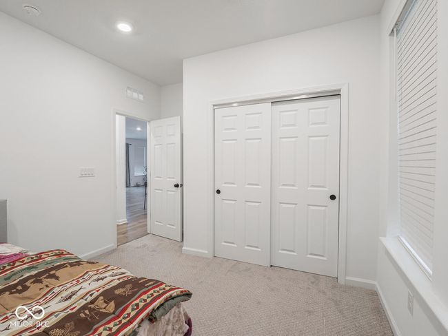 bedroom with a closet, visible vents, recessed lighting, light carpet, and baseboards | Image 25
