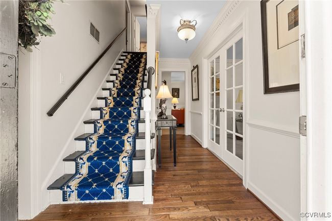 Foyer with stairway, wood finished floors, visible vents, french doors, and crown molding | Image 6