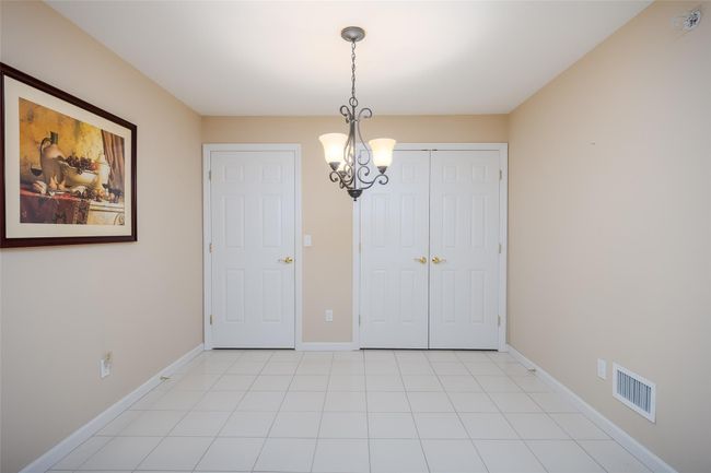 Unfurnished dining area featuring a chandelier and baseboards | Image 13