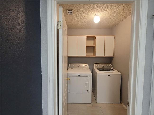 Laundry room featuring cabinet space and ceramic tile floors | Image 8