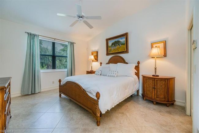 Tiled bedroom with vaulted ceiling and ceiling fan | Image 12
