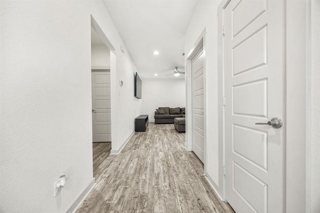 Step inside to a bright and welcoming hallway with stylish vinyl plank flooring, leading you into the main living areas of the home. | Image 6