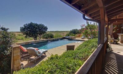 View of swimming pool featuring pool water feature | Image 3