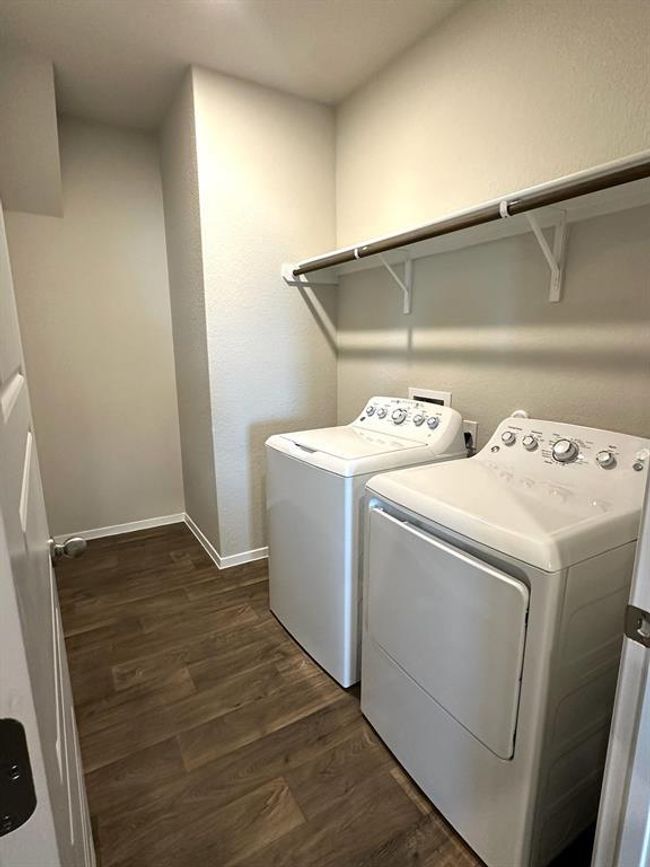 Laundry area featuring independent washer and dryer, dark wood-type flooring, and baseboards | Image 15