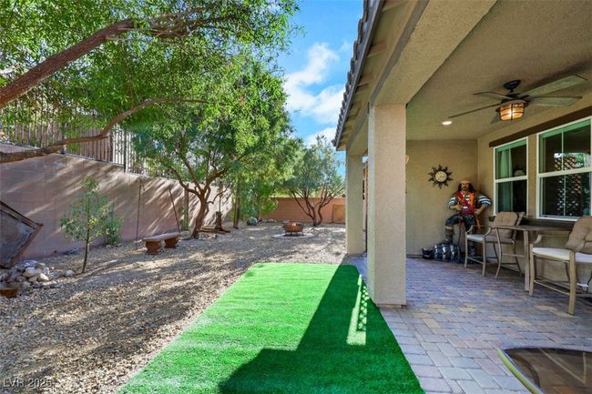 View of yard featuring ceiling fan, a fenced backyard, and a patio area | Image 35