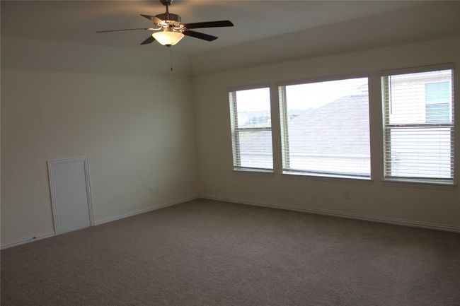 Carpeted spare room with a ceiling fan and baseboards | Image 9