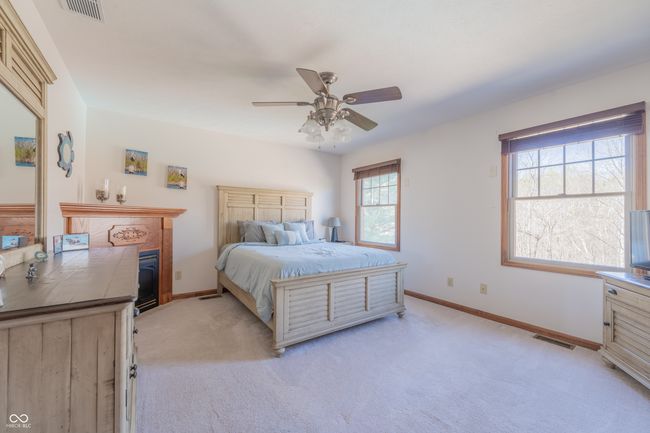 bedroom with light colored carpet, baseboards, and visible vents | Image 22