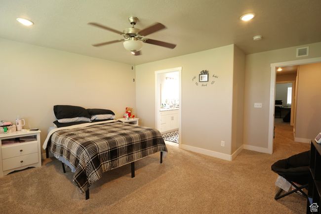 Bedroom with recessed lighting, light carpet, a ceiling fan, and ensuite bathroom | Image 5