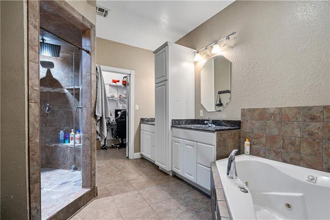 Bathroom with vanity and shower with separate bathtub | Image 30