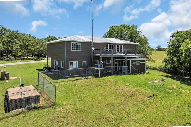 Rear view of property with a wooden deck and metal roof | Image 49
