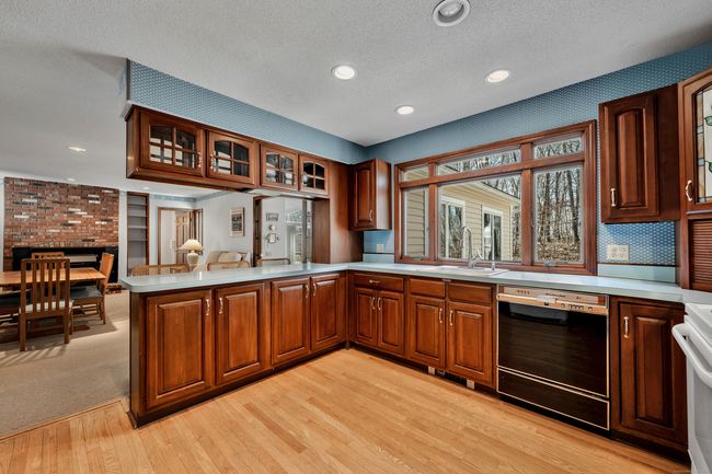 Large cherry kitchen with breakfast bar opens to family room | Image 8
