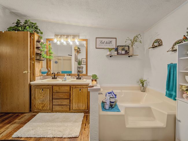 Bathroom featuring a bath, house one. | Image 12