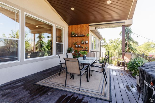 Wooden deck featuring outdoor dining area | Image 41