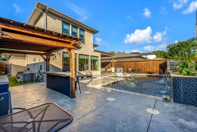 View of pool featuring a patio area and pool water feature | Image 16