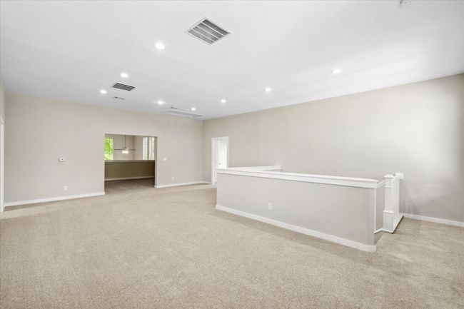 Upstairs Living room featuring light colored carpet, recessed lighting, and baseboards | Image 23