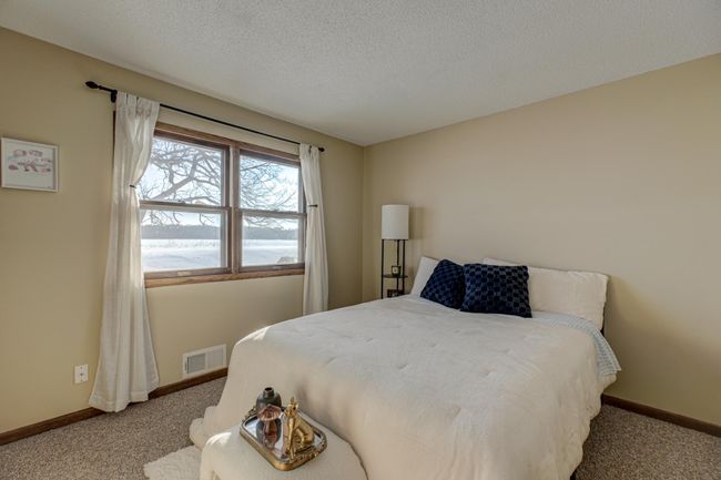The second bedroom on the main level offers gorgeous river views, providing a peaceful retreat just steps away from the action | Image 20