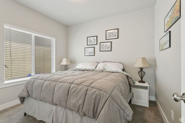 Bedroom with dark colored carpet and baseboards | Image 11