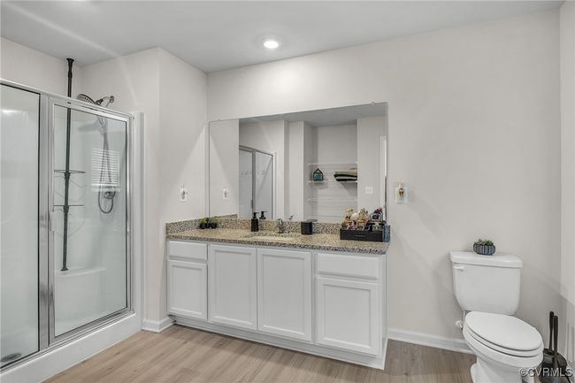Bathroom featuring vanity, wood finished floors, toilet, and a shower stall | Image 14