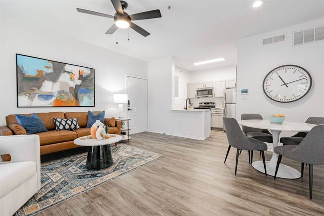 Living room featuring ceiling fan, sink, and light hardwood / wood-style flooring | Image 36